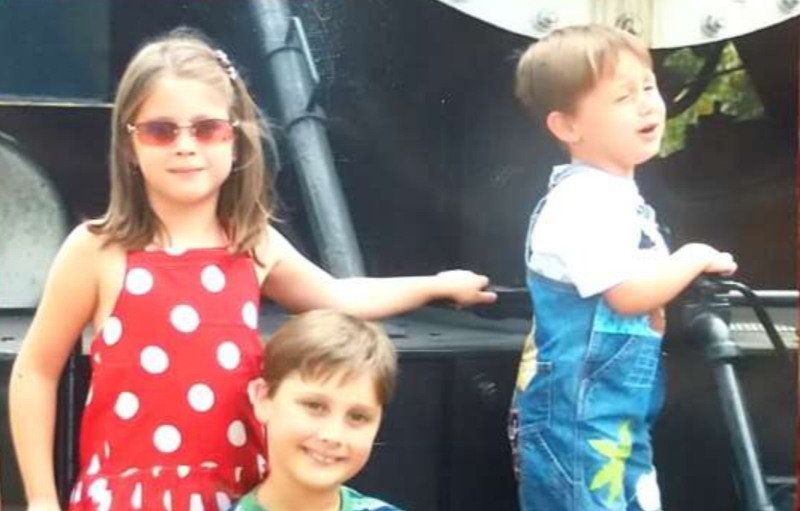 (From left to right) Siblings Sydney, Matthew and Joshua Smith stand on a train waiting for their picture to be taken. This picture  portrays three different types of people, and respectively their emotions. 
