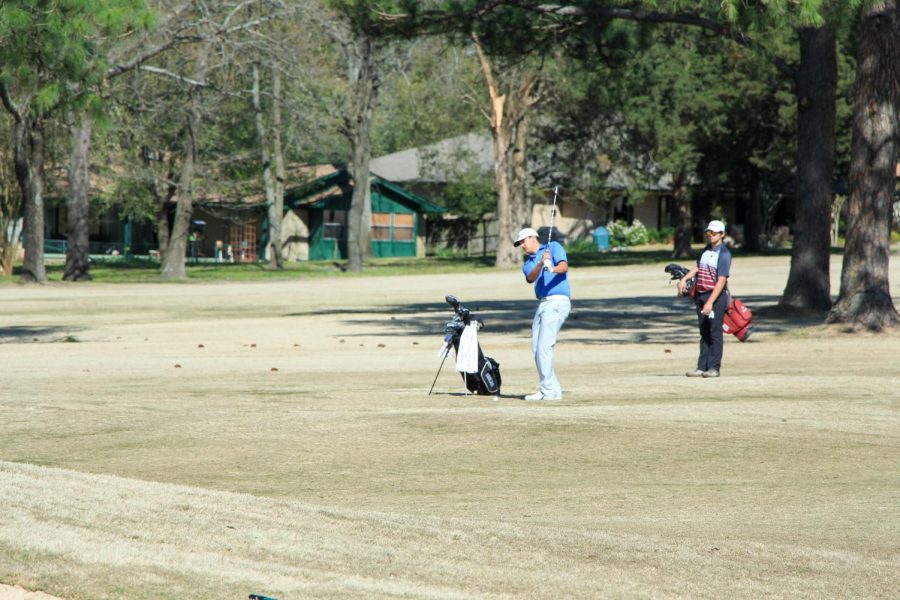 Senior Ryan Esparza practices his swing before hitting the golf ball. They began the tournament at 8 a.m.