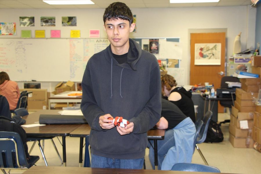 Junior Jose Tovar holds one of his needle felted sculptures. This is one of the three sculptures he has made using the needle felting technique in his art class.