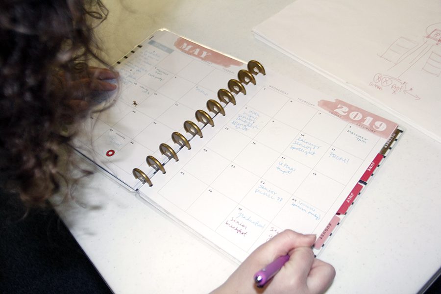 Annie Evans fills out her planner. She worked very hard to avoid stress her senior year.