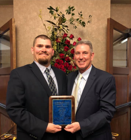 Coach Brent Ricks receives Chamber Educator of the year. Superintendent Stan Surratt congratulated him for his 8 years of coaching and teaching.