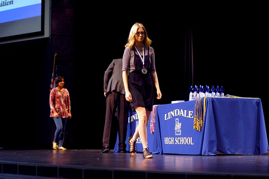 Senior Claudia Moore accepts her medal at the  Honors Ceremony.  Moore won first place in the Helen S. Boylan Foundation Art Contest.