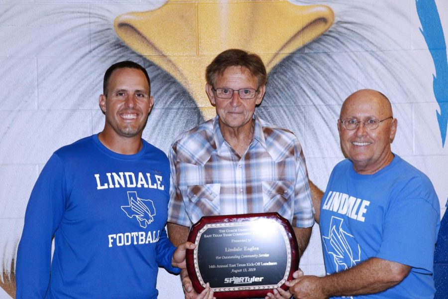 Head football coach Chris Cochran and Athletic Director Mike Maddox pose with award namesake Danny Palmer. The football program was chosen to receive the plaque for their service in the community. 