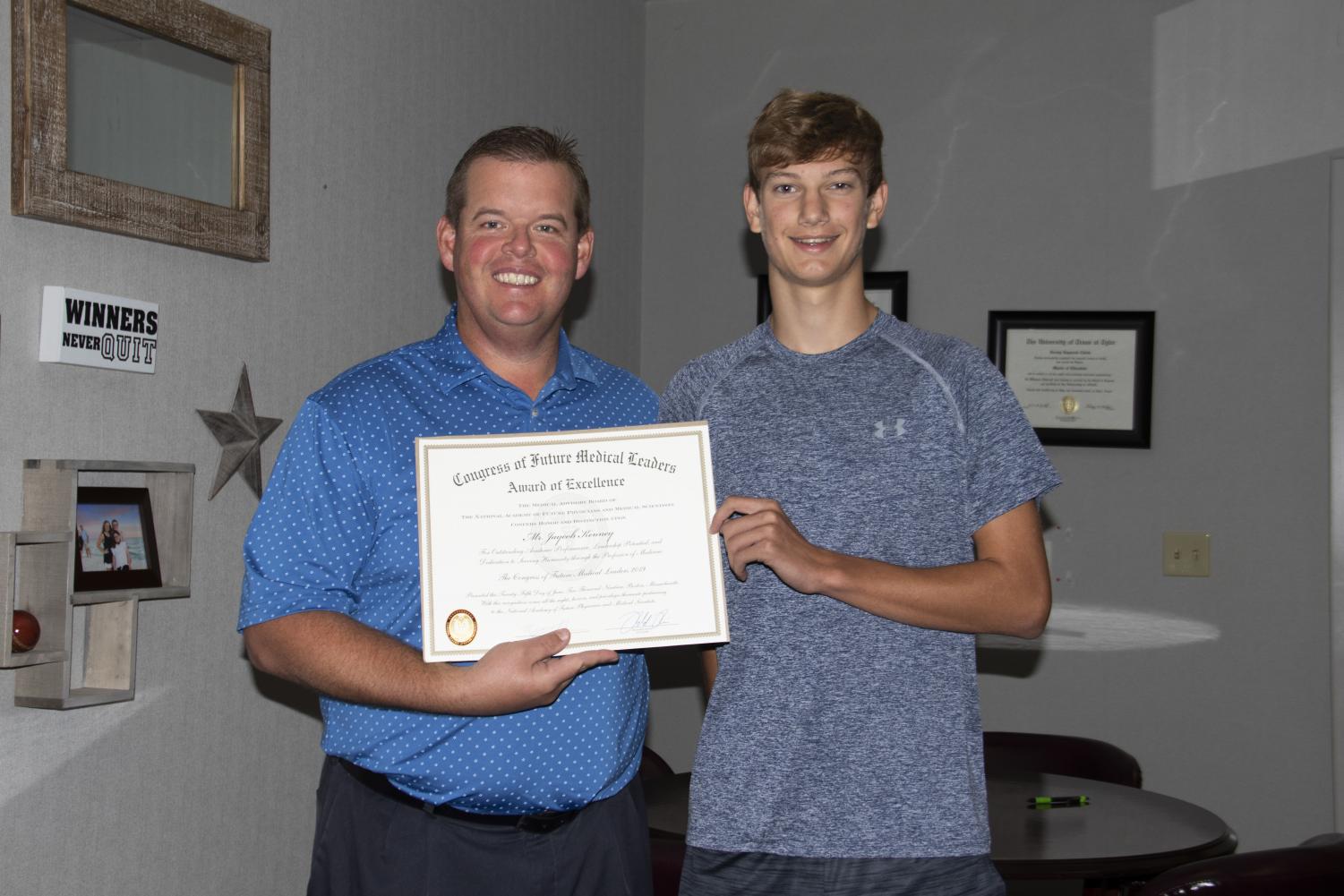 Junior Jaycob Kenney receives an award for his attendance at the Congress of Future Medical Leaders. Kenney was chosen to represent the State of Texas at the national congress