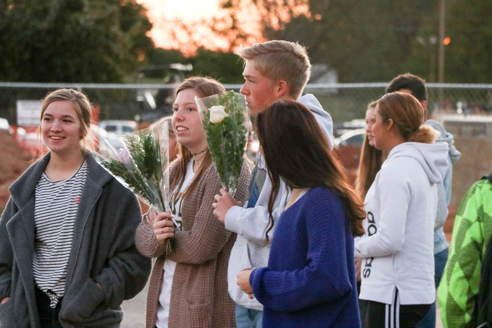 Floral design students wait in the student parking lot to pass out roses. Over 100 roses were passed out.