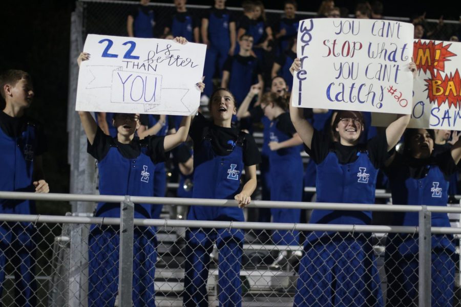 Band members hold up their signs for the football players after the game against Nacogdoches. They made signs for six different varsity players for that weeks game.