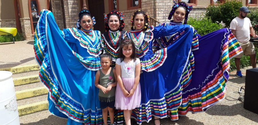 Spanish I teacher Sibul Rodriguez (second from left) and some other members of La Raíces pose for a picture after a presentation. The group was started last May by Rodriguez and her friend.