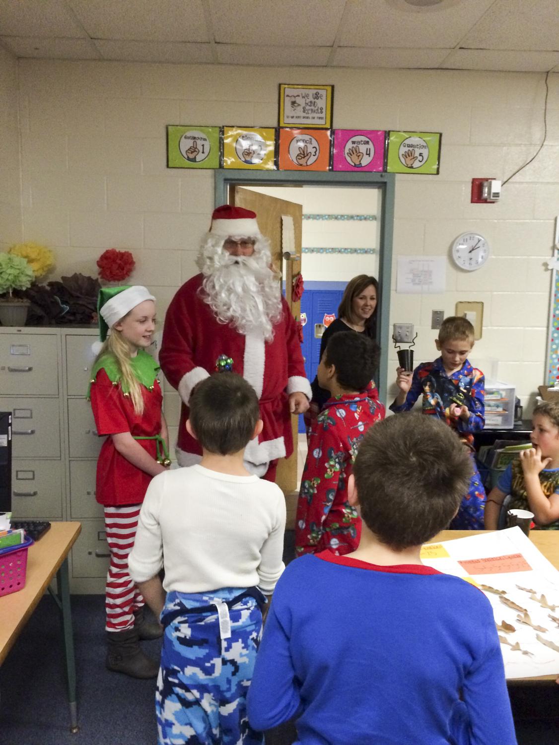 Coach John Phillips dressed up as Santa visits College Street Elementary. He visited different classrooms to spread the Christmas spirit.