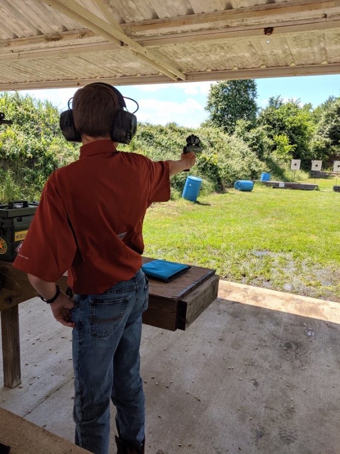 Freshman Austin Stone aims his pistol before he takes his shot. Austin has been shooting since he was nine and now competes with the group 4H in Texas.