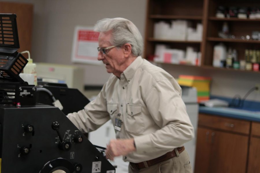 Retired teacher Tommy Mallory works in the print shop. He has worked for the district for 47 years.