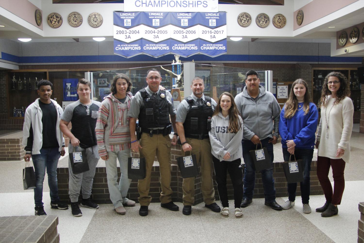 The Law Enforcement class poses while giving the campus police officers a goodie bag. This was to show support to the local police officers on National Law Enforcement Day.