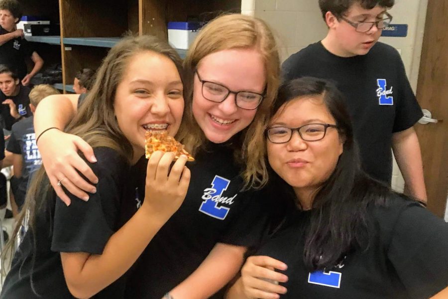 Sophomore Marlee Sorrells (middle) laughs with friends before her first high school football game. Band was a big part of how she managed her social anxiety when it became apparent in her life.