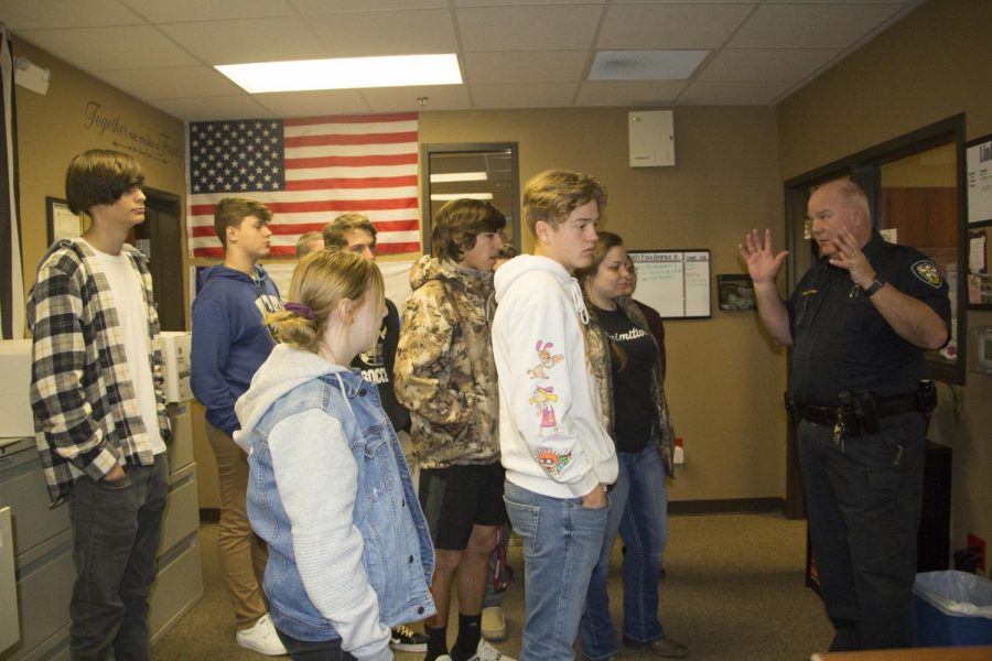 Chief Somes show the students the 911 dispatch area were the officers are given orders on were they need to go. He explained how important this room is the Lindale Police Department and how big of an impact it makes.