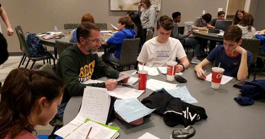 Science coach Duane Walton works with juniors Braden Heizer and Ferris Turney at the Mannsfield practice meet. The two will compete at UIL district on the 28th.