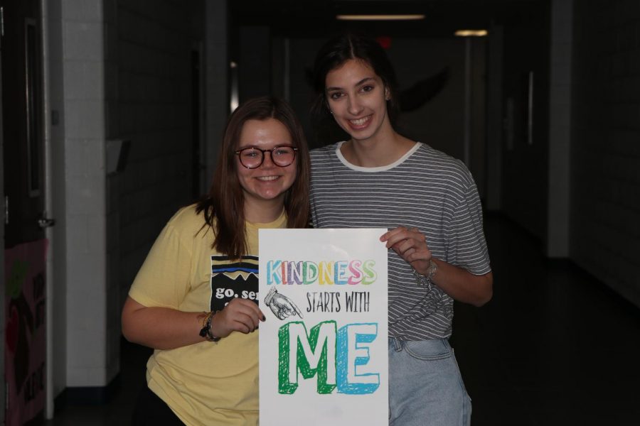 Juniors Abigail Powell (left) and Abby Payne (right) hold the Kindness Challenge sign. It was a week-long challenge that spread positivity around the school.