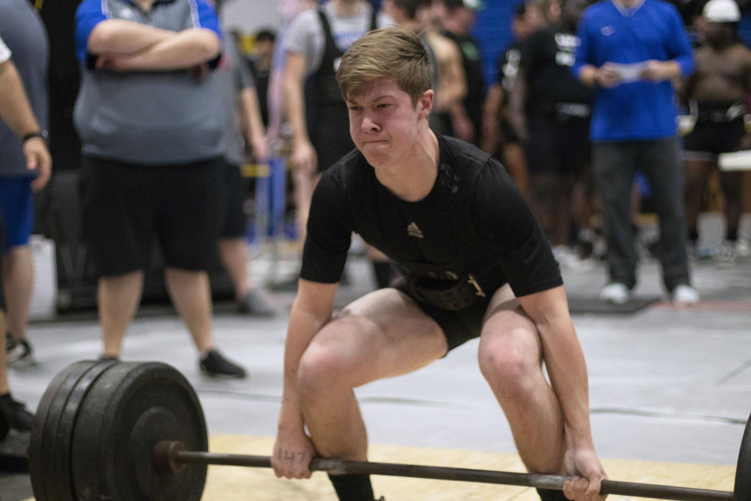 Senior Henry Waggoner lifts the bar off the ground. This was at one of the recent powerlifting meets.