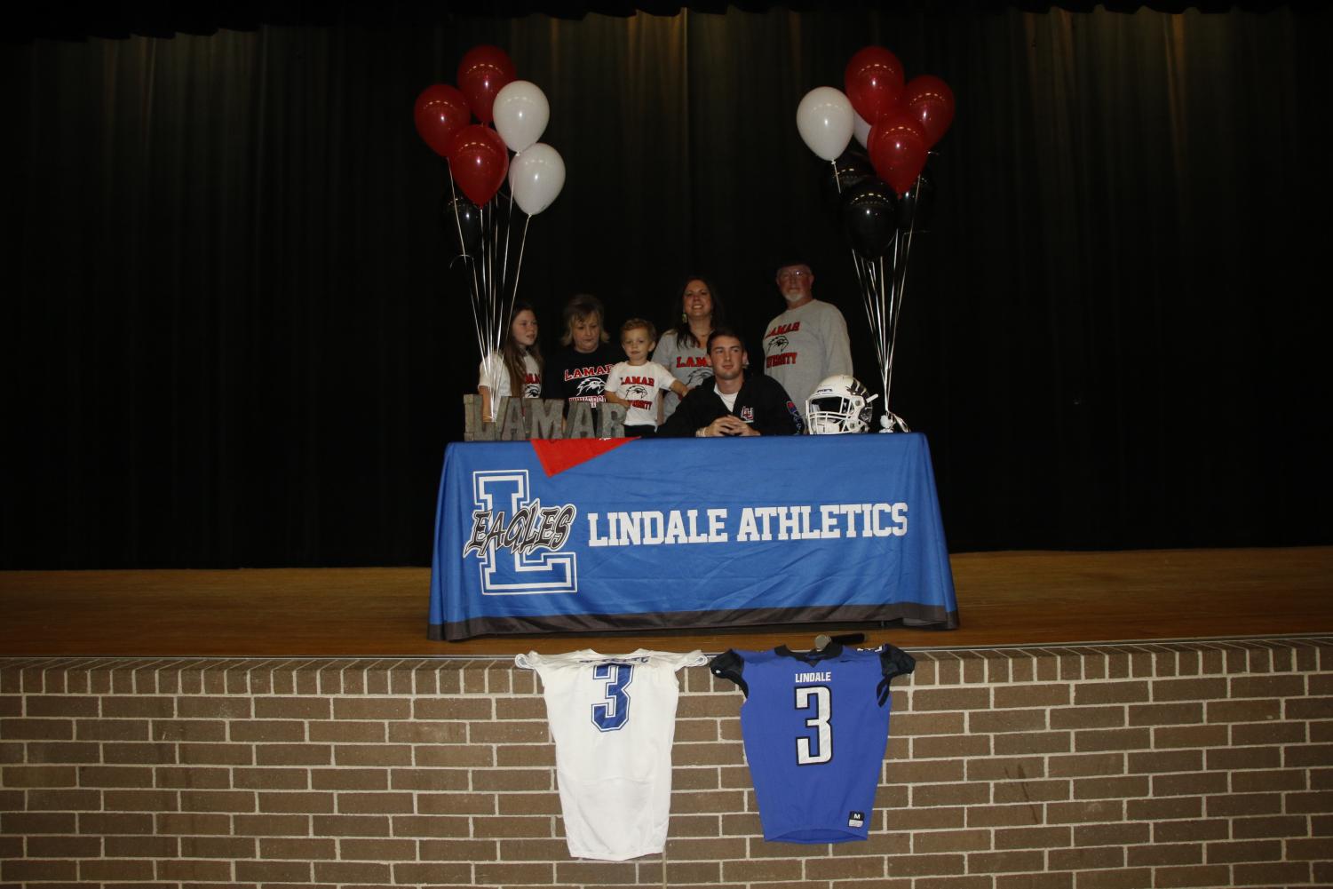 Senior Connor Boyette and his family stop for a picture after Boyette signs to become a preferred walk-on for college football. He will continue his career at Lamar University.