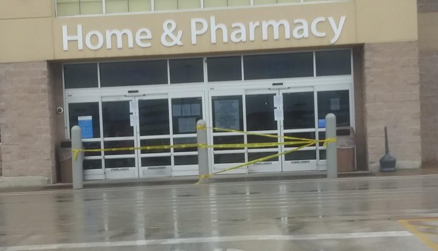 Tape+lines+the+front+of+one+entrance+of+Wal-Mart.+The+company+restricts+access+to+one+door+to+enter+the+building+and+a+separate+door+to+exit+to+avoid+customers+coming+into+contact+with+one+another.