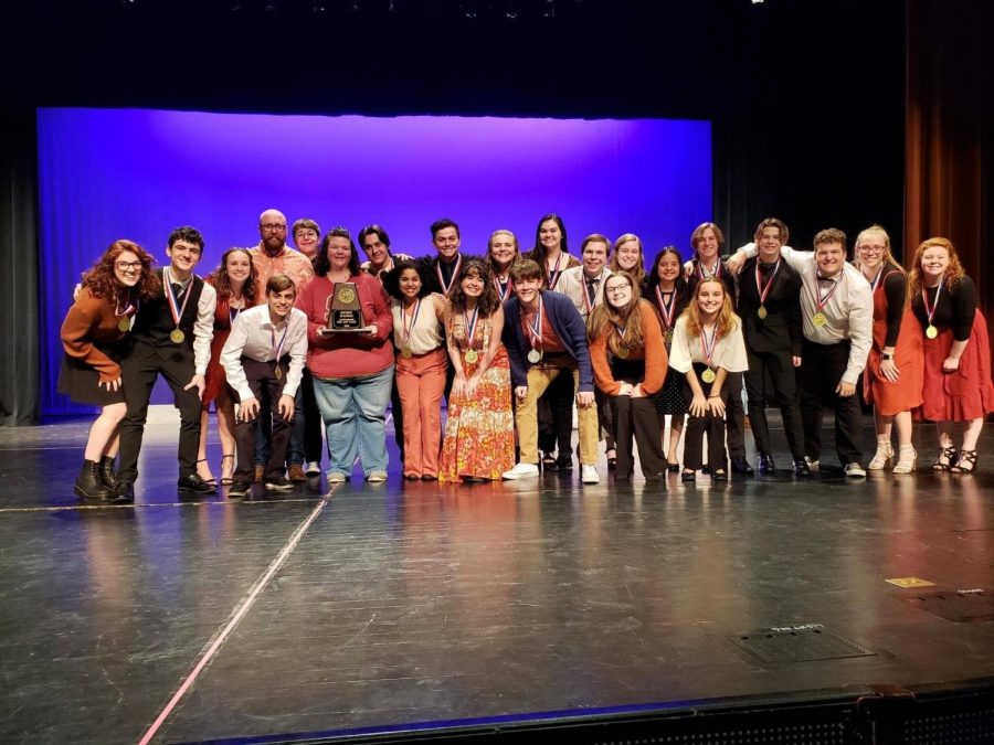 The cast of Nell Gwynn poses together on stage. They won first place at their district One Act Play competition.