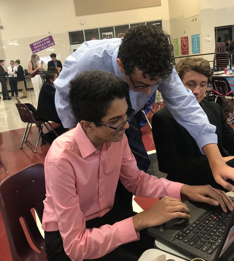 Sophomores Gavin James, Gunner Brown, and Aryan Patel look over speeches. They attended the  Wylie UIL debate meet before the coronavirus outbreak occurred.