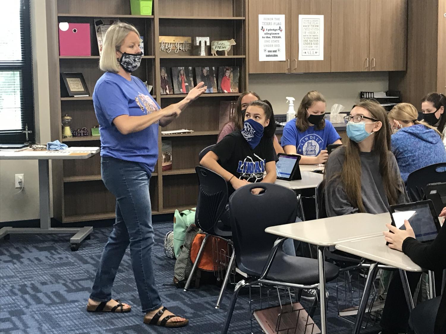 Amy Thompson instructs her students to start reading in sign language. “There was a push to get a few more foreign language options and Mr. Chilek was aware that I knew sign language,” Thompson said. ”I feel like it is my dream job.”
