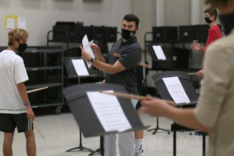 Kelley points out a specific part in the music the group is struggling with. The students were preparing for their chair test music.