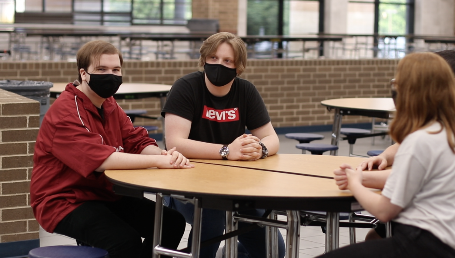 Seniors Zachary Jones and John Park sit across from sophomore Kylie Hester wearing their masks appropriately. Over the nose and secured under the chin is the most scientifically proven method by which masks should be worn. 