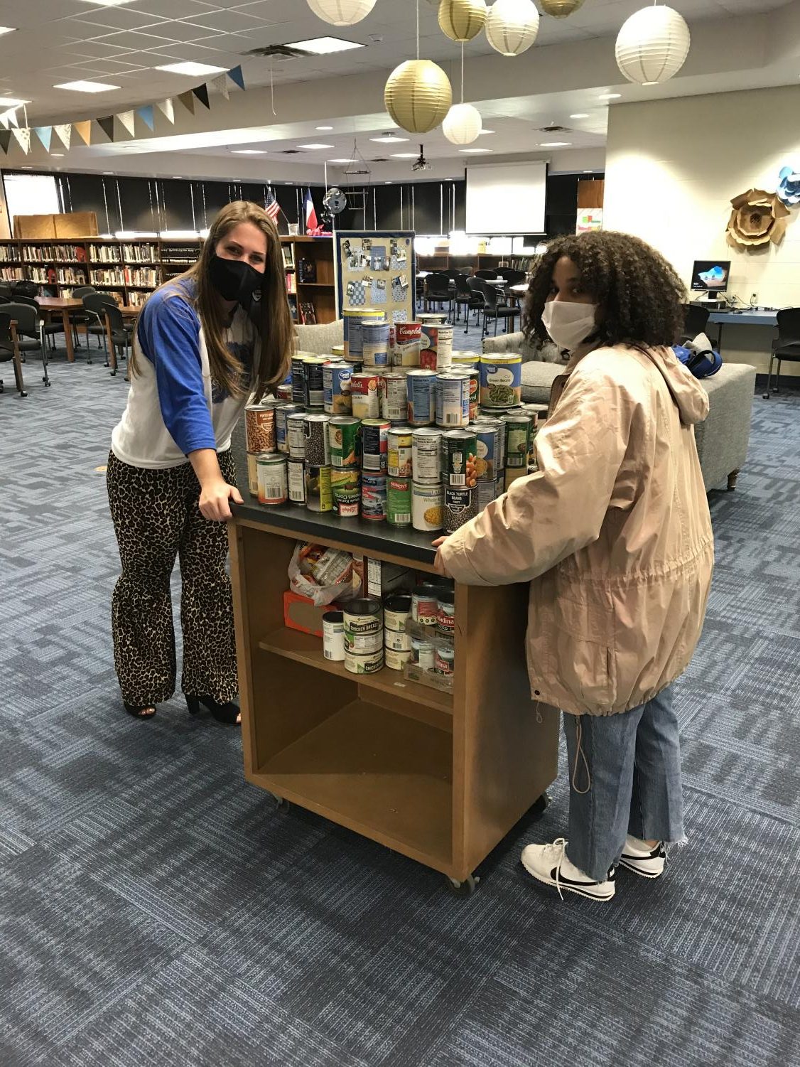 Members of the student council loads cans to transport to the David Powell Food Pantry. All cans will be donated to the pantry and distributed to families in need.
