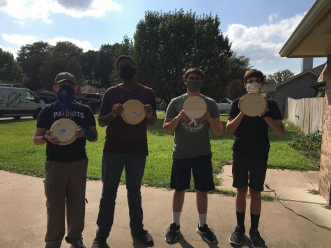 Junior Cody Peters (two from the right) presents the one of 50 plus sculpting wheels for his Eagle Scout Project and the Art Department.