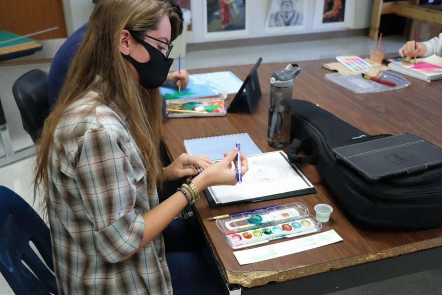 Senior Adelaide James works on her portrait. The portraits to Venezuela will be turned at the end of this month.