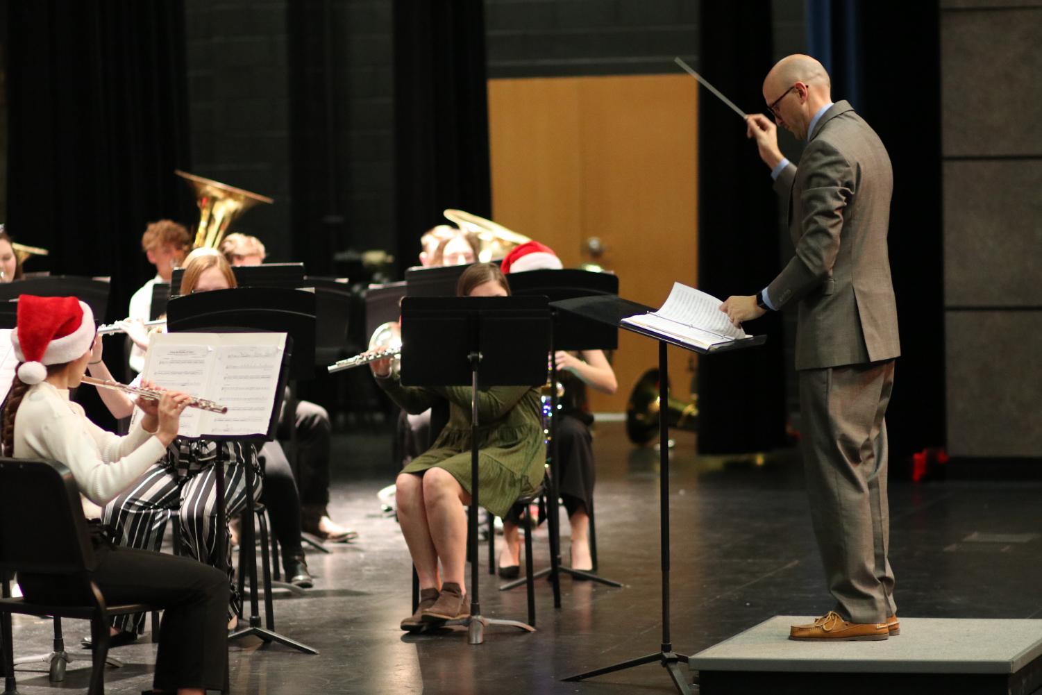 Weston Fisher directs the symphonic band during the Christmas concert. The Chistmas concert was the last thing the band did before they started preparing for the UIL Solo and Ensemble contest.
