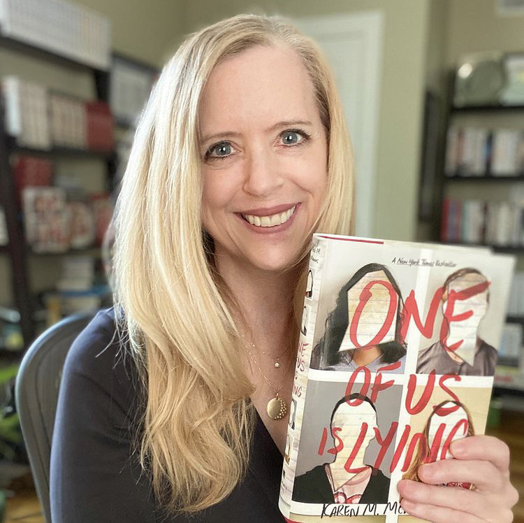 Author Karen M. McManus holds up her copy of One of Us is Lying. Her book has been on the New York Times Best Sellers List in the category Young Adult Hardcover for 160 weeks.