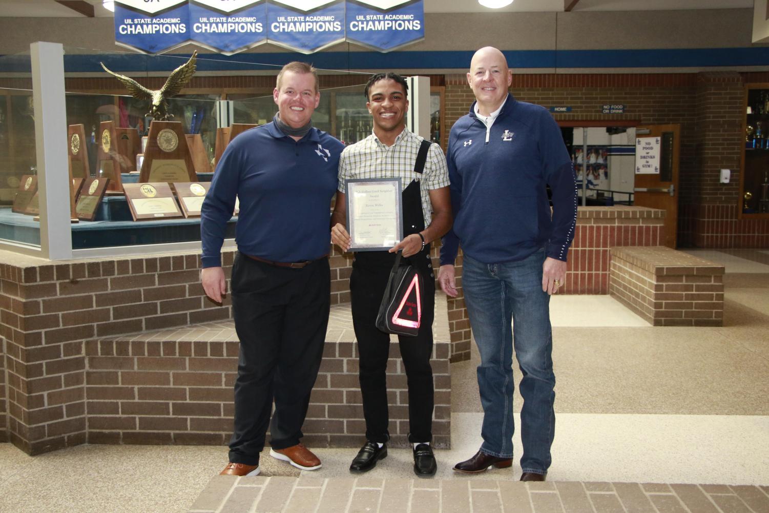 Senior Kevin Willis holds his award with prinicpal Jeremy Chilek and State Farm member RJ Collins. The award is for his efforts in maintaining the Lindale attributes.