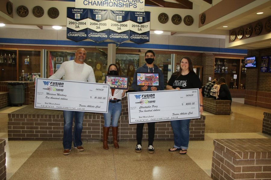 The winning students pose with their checks from the prize of the contest. I was really eager and thrilled to have the opportunity to show my art skills on a wall, freshman Christopher Perez said. I have been working on this for over a week.