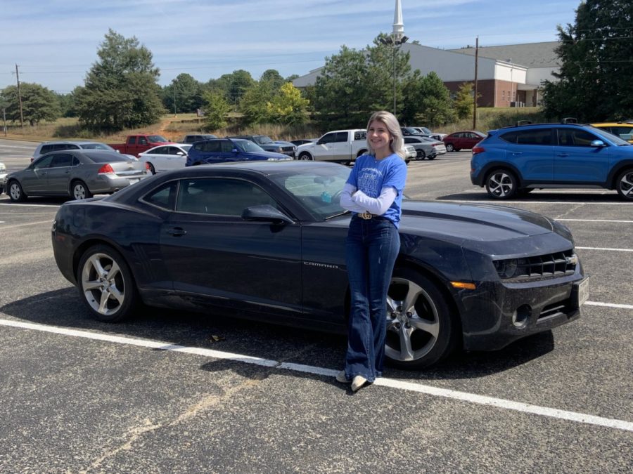 Senior Shelby Anderson stands by her Camaro.