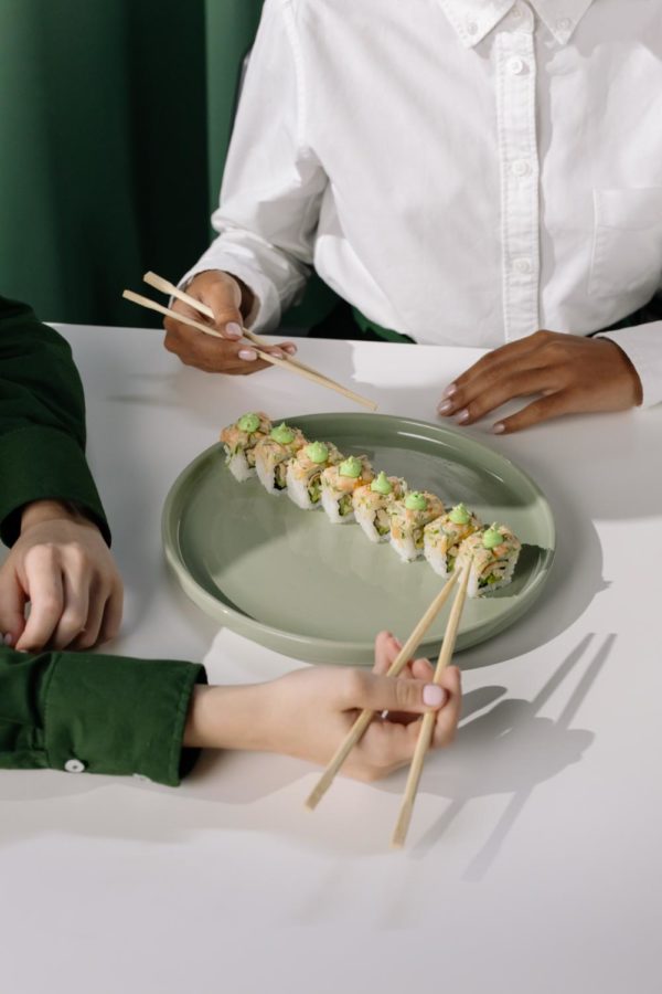 People eat sushi together.