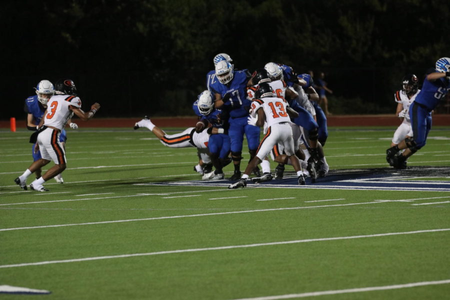 Football boys fight through Gilmer during the game.