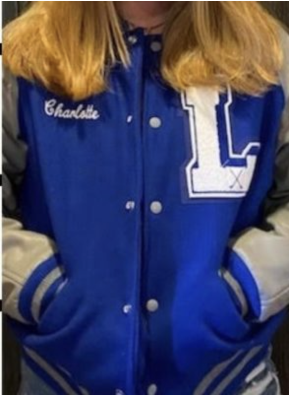 Sophomore Charlotte McConathy poses in her letter jacket. My jacket is very cute, McConathy said. 