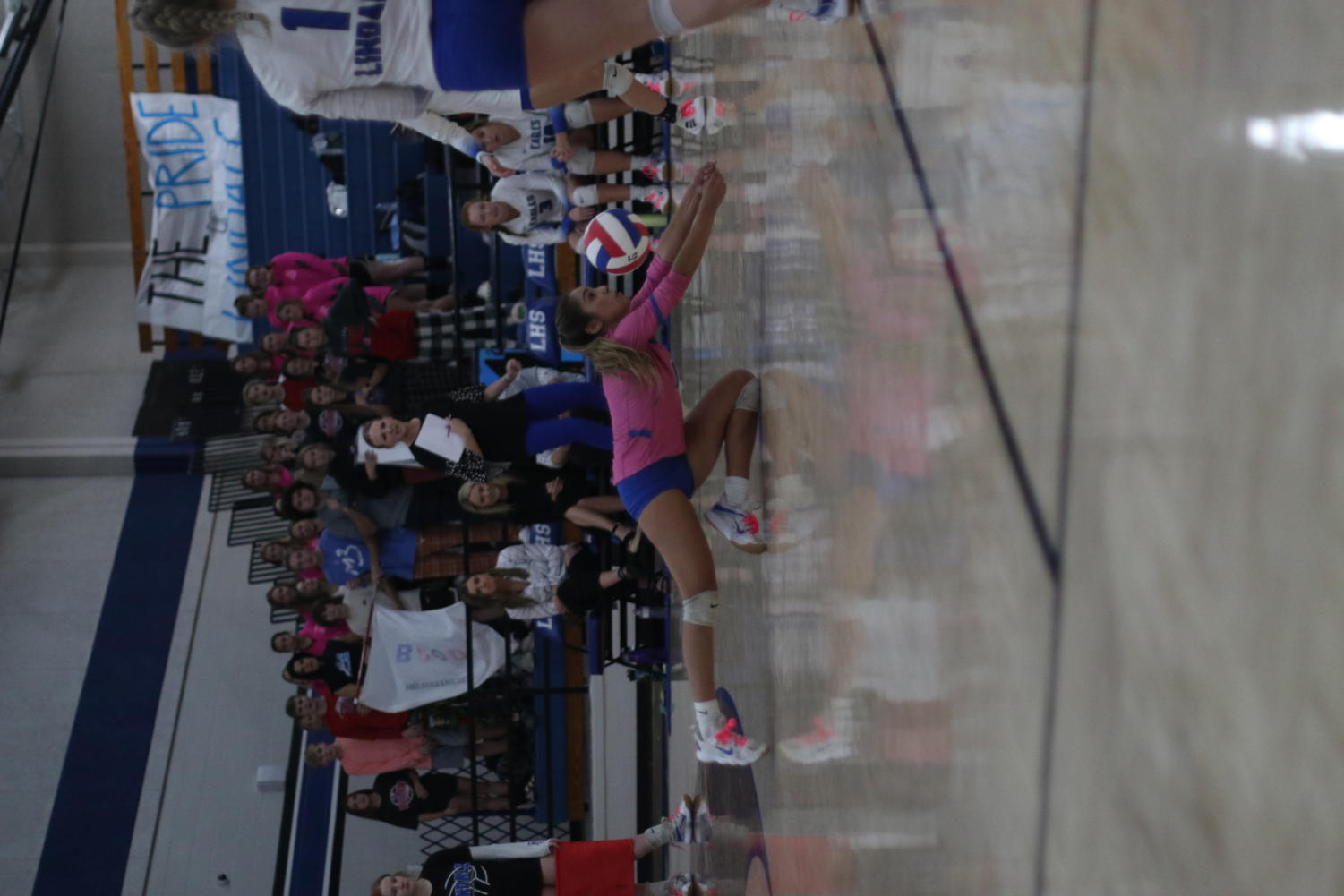 Senior Alondra Romero dives for the ball during the volleyball match.
