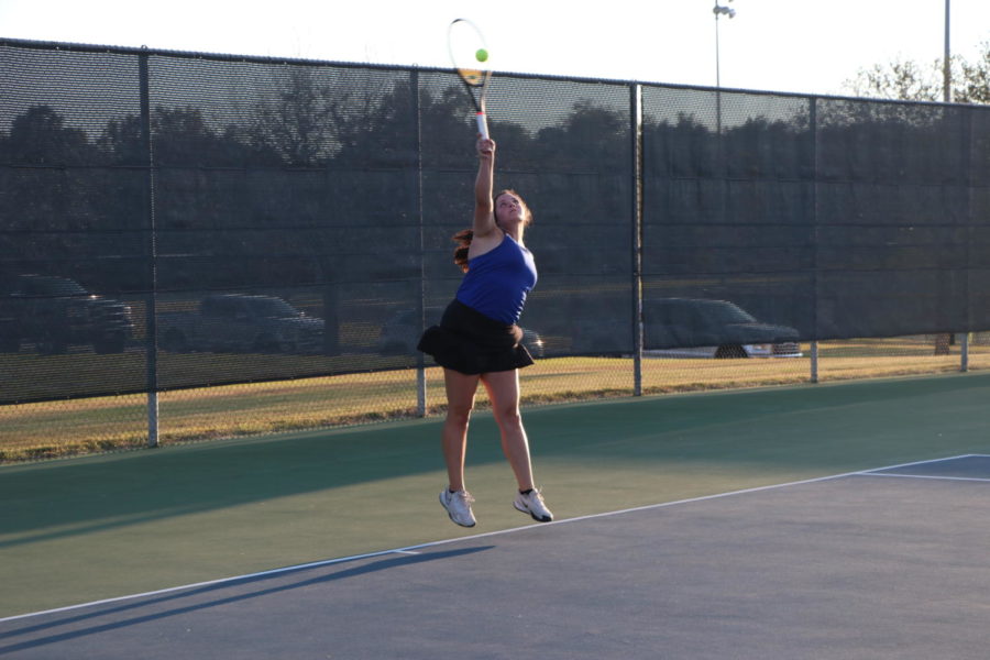Senior Brooklyn Gilleland serves in a competition. She competes on the Varsity team.