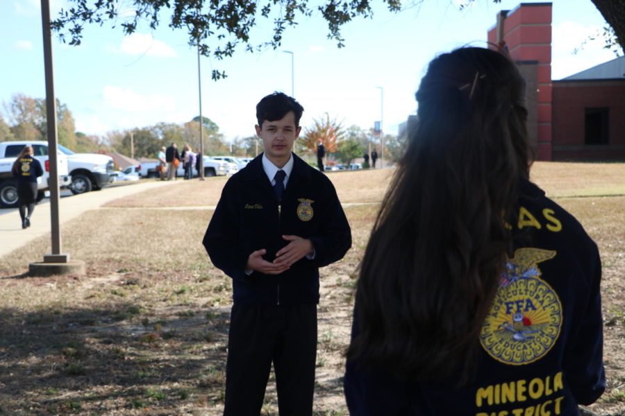 Junior Jacqueline Rand helps FFA students prepare their speeches before they leave for state.