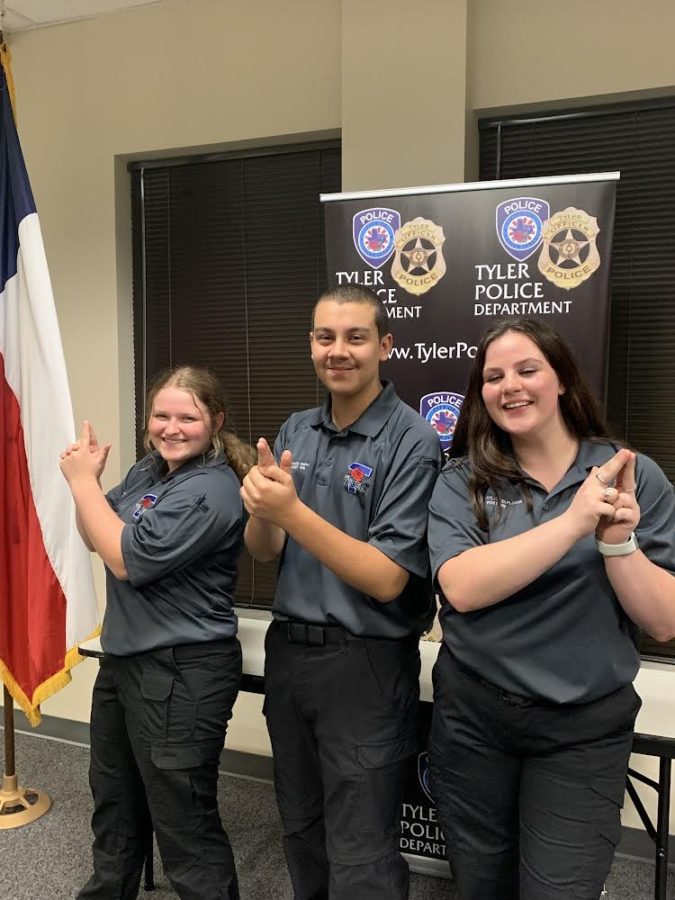 Juniors Trinity Boaz, Gwen May, and Cyrus Barron pose for a picture. They are all a part of the Tyler Police Explorer program.