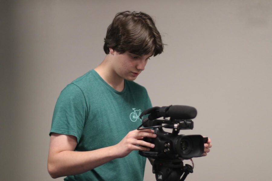 Eagle Vision member sets up camera for filming after school.