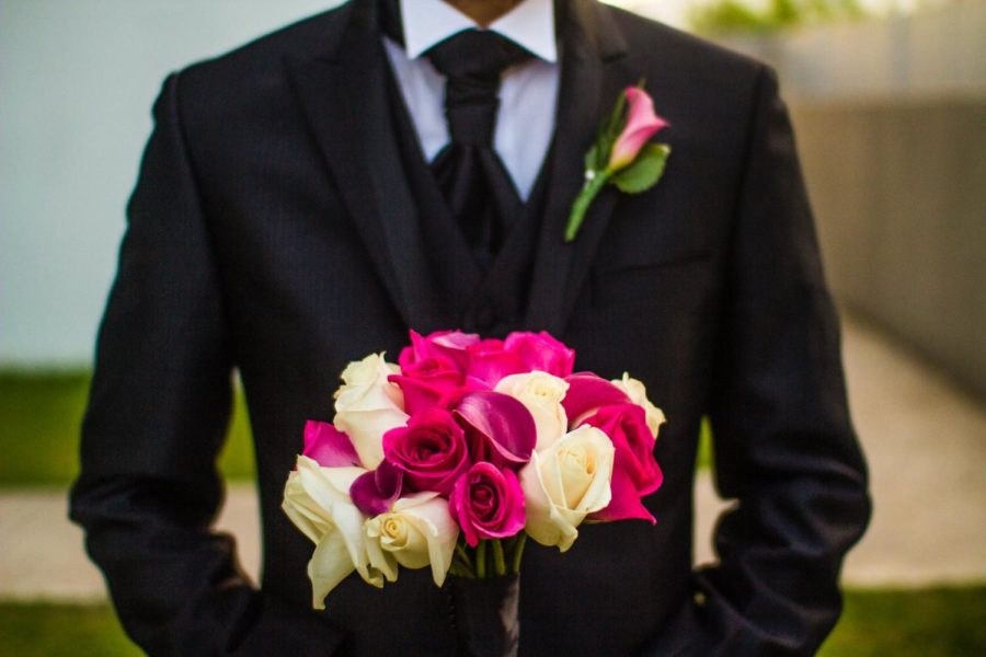 Man in suit with flowers.