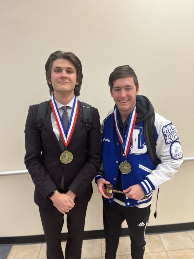 Senior George Bond and sophomore Jakob Davenport pose with their medals. They competed in CX District.