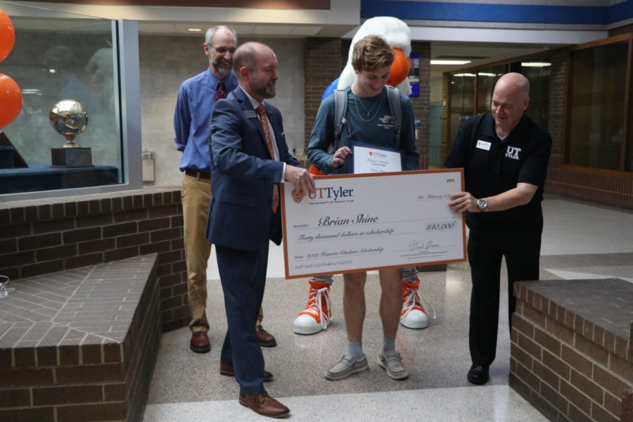 Senior Brian Shine receives scholarship from UT Tyler staff.“I really didn’t know what to expect,” Shine said. “When I walked up and saw the people from UT Tyler, a million things ran through my head about what I’ve been working towards and I couldn’t believe it was finally happening.”