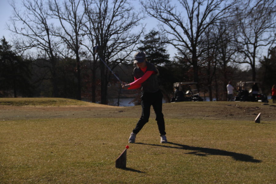 Freshman Kenzie McClenny drives the ball with her club to the hole.