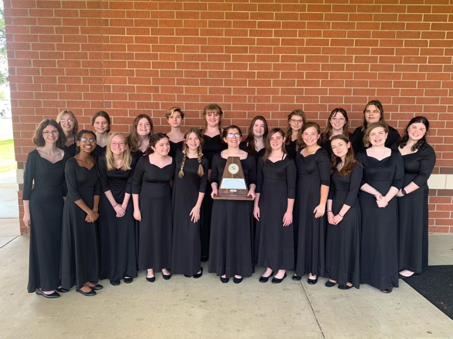 The Treble Choir poses around their first place trophy. The group received straight ones at the competition. 