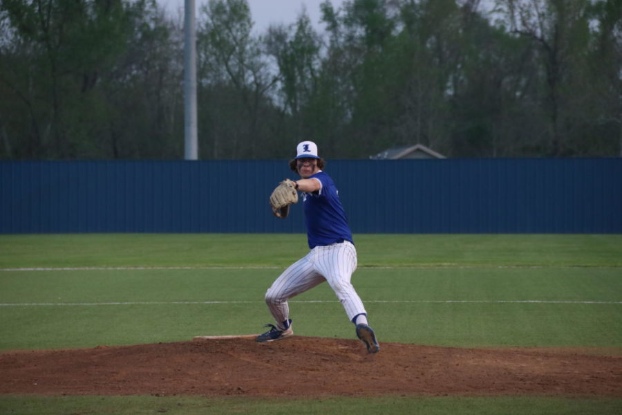 Varsity Eagles Baseball pitcher throws the ball to the opposing team.