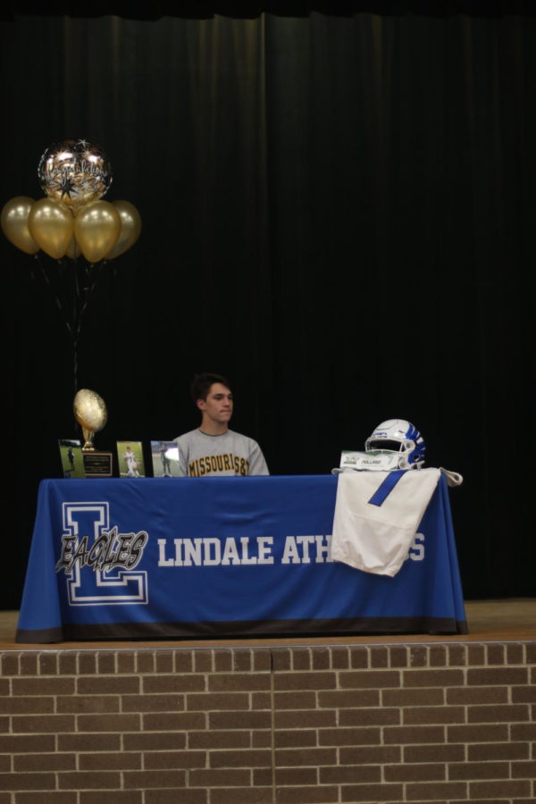 Senior Isaac Pollard signs to join a college football team.